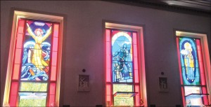 The chapel’s stained glass windows depict:  the biblical story of Jesus walking on water and calming the storm to reassure his disciples, a number of whom were fishermen; Gloucester’s famous “Man at the Wheel” statute.  (Photos courtesy of Vivien Li)