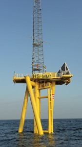 An example of a twisted jacket turbine foundation.  The wind turbine structure would be mounted atop the yellow foundation base where the girding is in this photo.  The unique foundation design came about through a competitive grant program sponsored by the Carbon Trust to encourage wind power development.  Built ashore, multiple units can be transported together providing significant cost savings. (Carbon Trust photo)