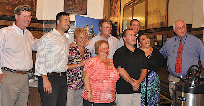 Gloucester Mayor Sefatia Romeo Theken and the Gloucester City Council also honored Sanfilippo for her many years of devoted service to the city and its fishing community and for protecting the oceans during a ceremony at Gloucester City Hall on Aug. 9.  And they saluted her for being named to the Boston Seafood Hall of Fame.  From left front, councilors Paul Lundberg, Joseph Orlando, Valerie Gilman, Sanfilippo, council vice-president Steven LeBlanc, Mayor Theken, and council president Joseph Ciolino.  From left back, councilors Scott Memhard and James O’Hara.  (Susan Pollack photos)